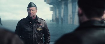 Movie still from “Midway” (2019), directed by Roland Emmerich – A man wearing a leather jacket and a hat; Close Up shot, Over the shoulder angle
