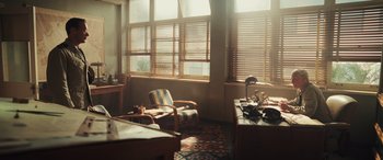 Movie still from “Midway” (2019), directed by Roland Emmerich – A room with a desk , chair , and a large window; Extreme Wide shot, High angle
