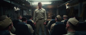 Movie still from “Midway” (2019), directed by Roland Emmerich – A man standing in front of a group of men; Medium shot, Low angle