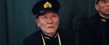 Movie still from “Midway” (2019), directed by Roland Emmerich – An older man wearing a hat and a uniform; Close Up shot, Low angle