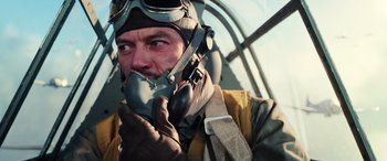 Movie still from “Midway” (2019), directed by Roland Emmerich – A person wearing a helmet and gloves; Close Up shot, Low angle