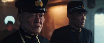Movie still from “Midway” (2019), directed by Roland Emmerich – A man in a uniform and a man in a uniform; Close Up shot, Over the shoulder angle