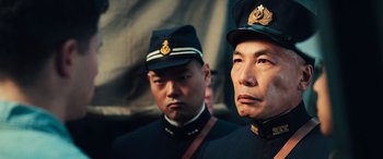 Movie still from “Midway” (2019), directed by Roland Emmerich – Two men in military uniforms standing next to each other; Close Up shot, Low angle