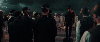 Movie still from “Midway” (2019), directed by Roland Emmerich – A group of men standing next to each other on a dock; Wide shot, Low angle