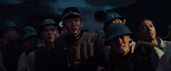 Movie still from “Midway” (2019), directed by Roland Emmerich – A group of men in military uniforms standing together; Medium shot, Low angle