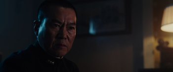Movie still from “Midway” (2019), directed by Roland Emmerich – An older asian man in a dark room; Close Up shot, Low angle