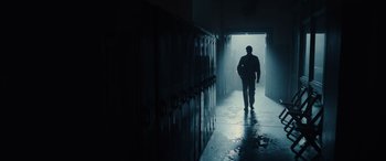 Movie still from “Midway” (2019), directed by Roland Emmerich – A man is walking through a hallway in a building; Wide shot, Low angle