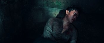 Movie still from “Midway” (2019), directed by Roland Emmerich – A man laying on the ground with blood all over his face; Medium shot, Overhead angle