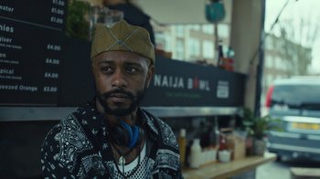 Movie still from “Atlanta” (2016), created by Donald Glover – A man with a hat and headphones on; Close Up shot, Low angle