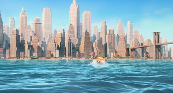 Movie still from “Minions” (2015), directed by Pierre Coffin – A man swimming in a body of water with a city in the background; Extreme Wide shot, High angle