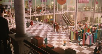 Movie still from “Minions” (2015), directed by Pierre Coffin – An indoor shopping mall with people walking around; Extreme Wide shot, High angle