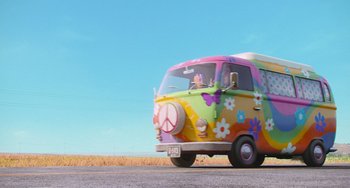 Movie still from “Minions” (2015), directed by Pierre Coffin – A van with a peace sign painted on the side of the road; Wide shot, Low angle