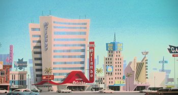 Movie still from “Minions” (2015), directed by Pierre Coffin – An illustration of an old motel in the middle of a city; Extreme Wide shot, Low angle