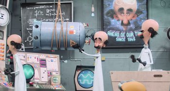 Movie still from “Minions” (2015), directed by Pierre Coffin – A fake head is hanging from the wall; Medium shot, Low angle