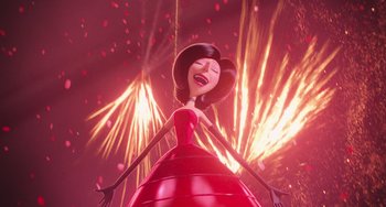 Movie still from “Minions” (2015), directed by Pierre Coffin – A woman in a red ball gown with fireworks in the background; Medium shot, Low angle
