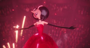 Movie still from “Minions” (2015), directed by Pierre Coffin – A woman in a red dress is smiling; Medium shot, Low angle