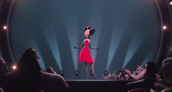 Movie still from “Minions” (2015), directed by Pierre Coffin – A woman in a red dress on a runway; Medium shot, Low angle