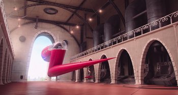 Movie still from “Minions” (2015), directed by Pierre Coffin – An airplane is in the middle of an indoor area; Extreme Wide shot, Low angle
