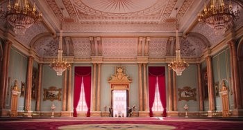 Movie still from “Minions” (2015), directed by Pierre Coffin – A large room with red draperies and red curtains; Extreme Wide shot, Low angle