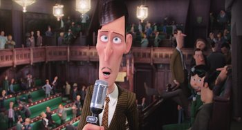 Movie still from “Minions” (2015), directed by Pierre Coffin – An animated man with a microphone in front of an audience; Medium shot, Low angle