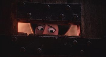 Movie still from “Minions” (2015), directed by Pierre Coffin – A woman peeking through a metal gate with her eyes wide open; Close Up shot, Over the shoulder angle