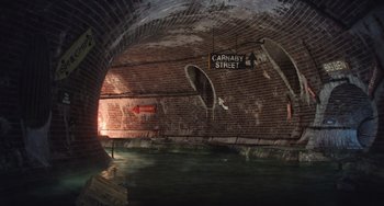 Movie still from “Minions” (2015), directed by Pierre Coffin – A brick tunnel with a sign that reads " carnaby street "; Extreme Wide shot, High angle