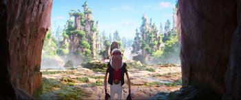 Movie still from “Minions: The Rise of Gru” (2022), directed by Jonathan del Val – A man with a helmet on his head standing in front of a forest; Wide shot, Low angle