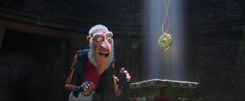 Movie still from “Minions: The Rise of Gru” (2022), directed by Jonathan del Val – A man with a white beard and a red shirt is looking at a donut; Medium shot, Over the shoulder angle