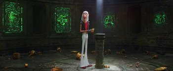 Movie still from “Minions: The Rise of Gru” (2022), directed by Jonathan del Val – A man with a long white hair and a red vest is holding a banana; Wide shot, Low angle