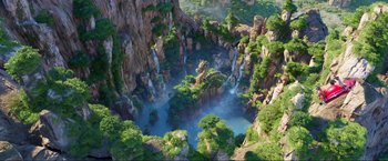Movie still from “Minions: The Rise of Gru” (2022), directed by Jonathan del Val – An aerial view of an island with a waterfall; Extreme Wide shot, High angle