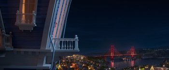Movie still from “Minions: The Rise of Gru” (2022), directed by Jonathan del Val – A view of a bridge from a balcony at night time; Extreme Wide shot, High angle