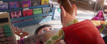 Movie still from “Minions: The Rise of Gru” (2022), directed by Jonathan del Val – An animated character looking in a mirror; Medium shot, Over the shoulder angle