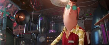 Movie still from “Minions: The Rise of Gru” (2022), directed by Jonathan del Val – A man in a red shirt and green sunglasses; Medium shot, Low angle