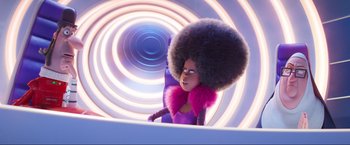 Movie still from “Minions: The Rise of Gru” (2022), directed by Jonathan del Val – A woman with a large afro in front of a spiral background; Medium shot, Low angle