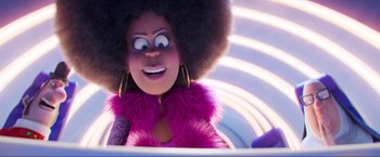 Movie still from “Minions: The Rise of Gru” (2022), directed by Jonathan del Val – A doll with a purple jacket; Close Up shot, Over the shoulder angle
