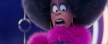 Movie still from “Minions: The Rise of Gru” (2022), directed by Jonathan del Val – A doll's face in a purple outfit; Close Up shot, Over the shoulder angle