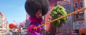 Movie still from “Minions: The Rise of Gru” (2022), directed by Jonathan del Val – A woman in a purple outfit pulling a rope; Medium shot, Over the shoulder angle