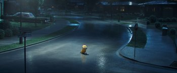 Movie still from “Minions: The Rise of Gru” (2022), directed by Jonathan del Val – A yellow fire hydrant sitting in the middle of a street; Extreme Wide shot, High angle