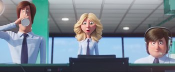 Movie still from “Minions: The Rise of Gru” (2022), directed by Jonathan del Val – A woman with blonde hair and a blue tie; Medium shot, Low angle