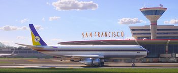 Movie still from “Minions: The Rise of Gru” (2022), directed by Jonathan del Val – An airplane parked at an airport with a sign on top of it; Extreme Wide shot, Low angle