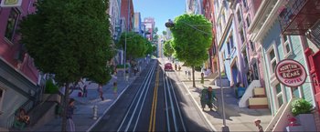 Movie still from “Minions: The Rise of Gru” (2022), directed by Jonathan del Val – A painting of an empty city street with cars driving down the street; Extreme Wide shot, Low angle