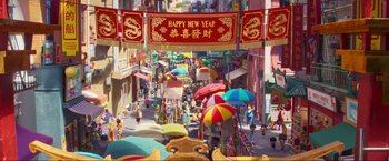 Movie still from “Minions: The Rise of Gru” (2022), directed by Jonathan del Val – An image of an asian street with many people and colorful umbrellas; Extreme Wide shot, Overhead angle