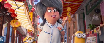 Movie still from “Minions: The Rise of Gru” (2022), directed by Jonathan del Val – An animated character is standing in the street; Close Up shot, Low angle