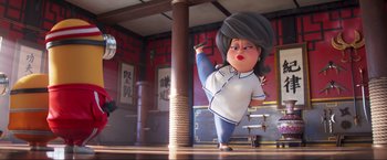 Movie still from “Minions: The Rise of Gru” (2022), directed by Jonathan del Val – An animated character is standing in a room; Wide shot, Low angle