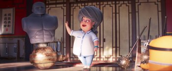 Movie still from “Minions: The Rise of Gru” (2022), directed by Jonathan del Val – An animated character is standing in front of an asian temple; Medium shot, Low angle