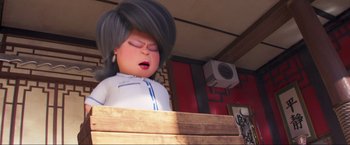 Movie still from “Minions: The Rise of Gru” (2022), directed by Jonathan del Val – An animated character is sleeping on a wooden bench; Close Up shot, Low angle