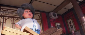 Movie still from “Minions: The Rise of Gru” (2022), directed by Jonathan del Val – An image of an animated character in a restaurant setting; Medium shot, Low angle