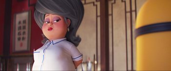 Movie still from “Minions: The Rise of Gru” (2022), directed by Jonathan del Val – An animated character with long black hair and a white shirt; Close Up shot, Low angle