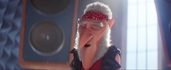 Movie still from “Minions: The Rise of Gru” (2022), directed by Jonathan del Val – An animated character wearing a red bandanna and a leather jacket; Close Up shot, Over the shoulder angle