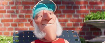 Movie still from “Minions: The Rise of Gru” (2022), directed by Jonathan del Val – An animated man with a beard wearing a blue hat; Close Up shot, Low angle